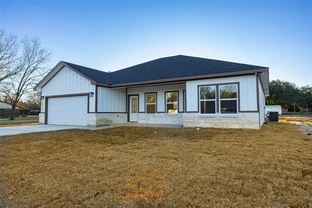 a house that has a large pool in front of it