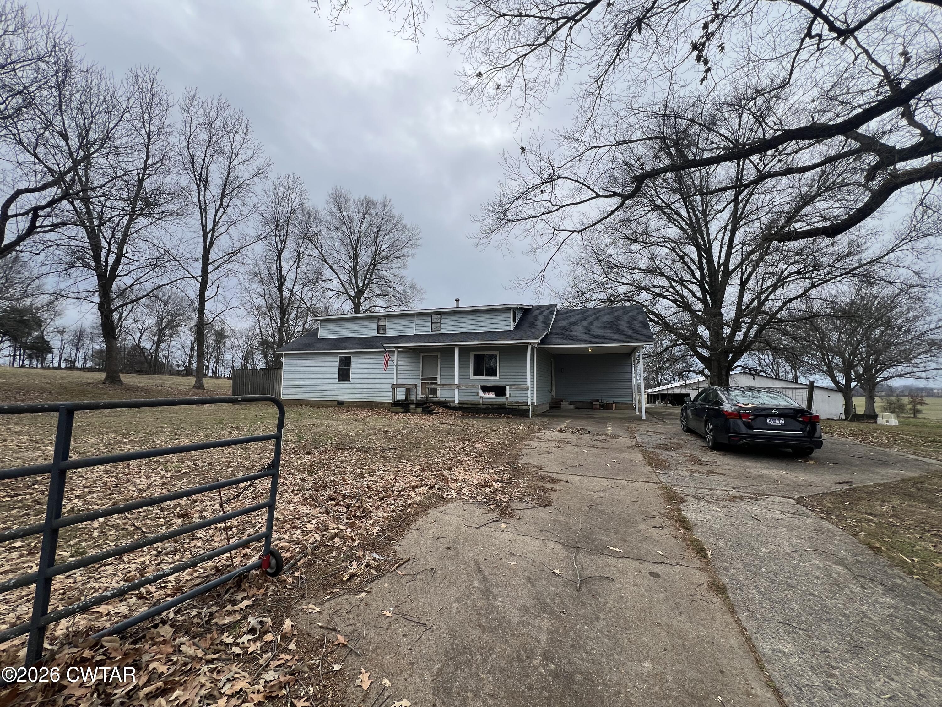 a view of a house with a yard covered in snow