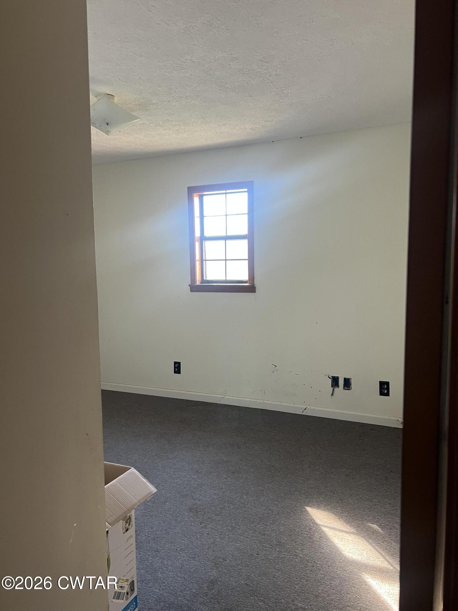 1527 Ashley Road Dyersburg, TN 38024 - Photo 7 of 14 an empty room with a window