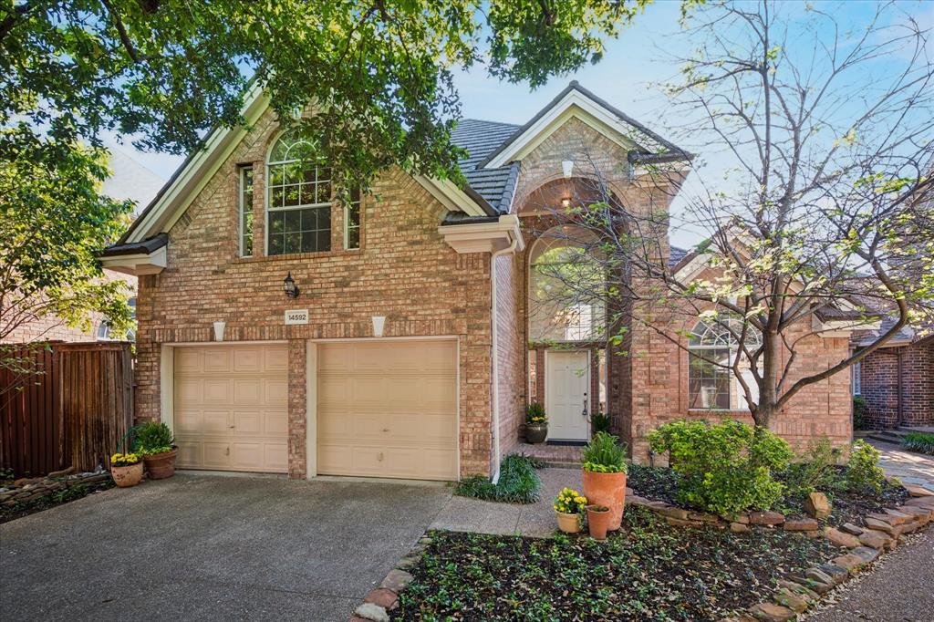 14592 Greenleaf Court Addison, TX 75001 - Photo 1 of 34 Traditional-style house featuring an attached garage, driveway, and brick siding