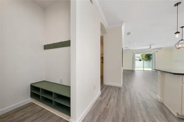 a large kitchen with stainless steel appliances kitchen island a large counter top and a wooden floors