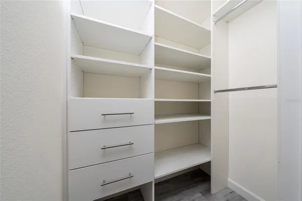 a view of a room with wooden floor and closet