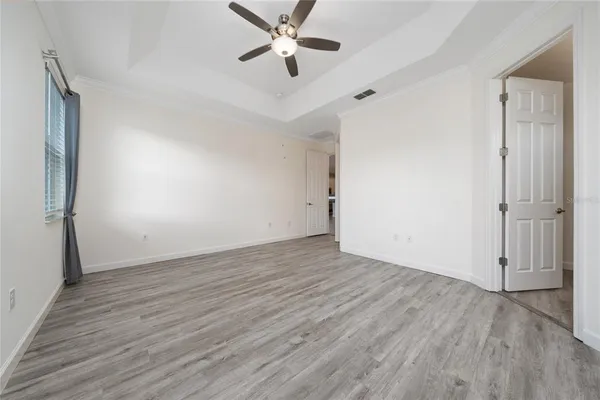 a view of walk in closet with empty racks