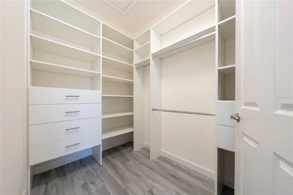 a room with white cabinets and sink