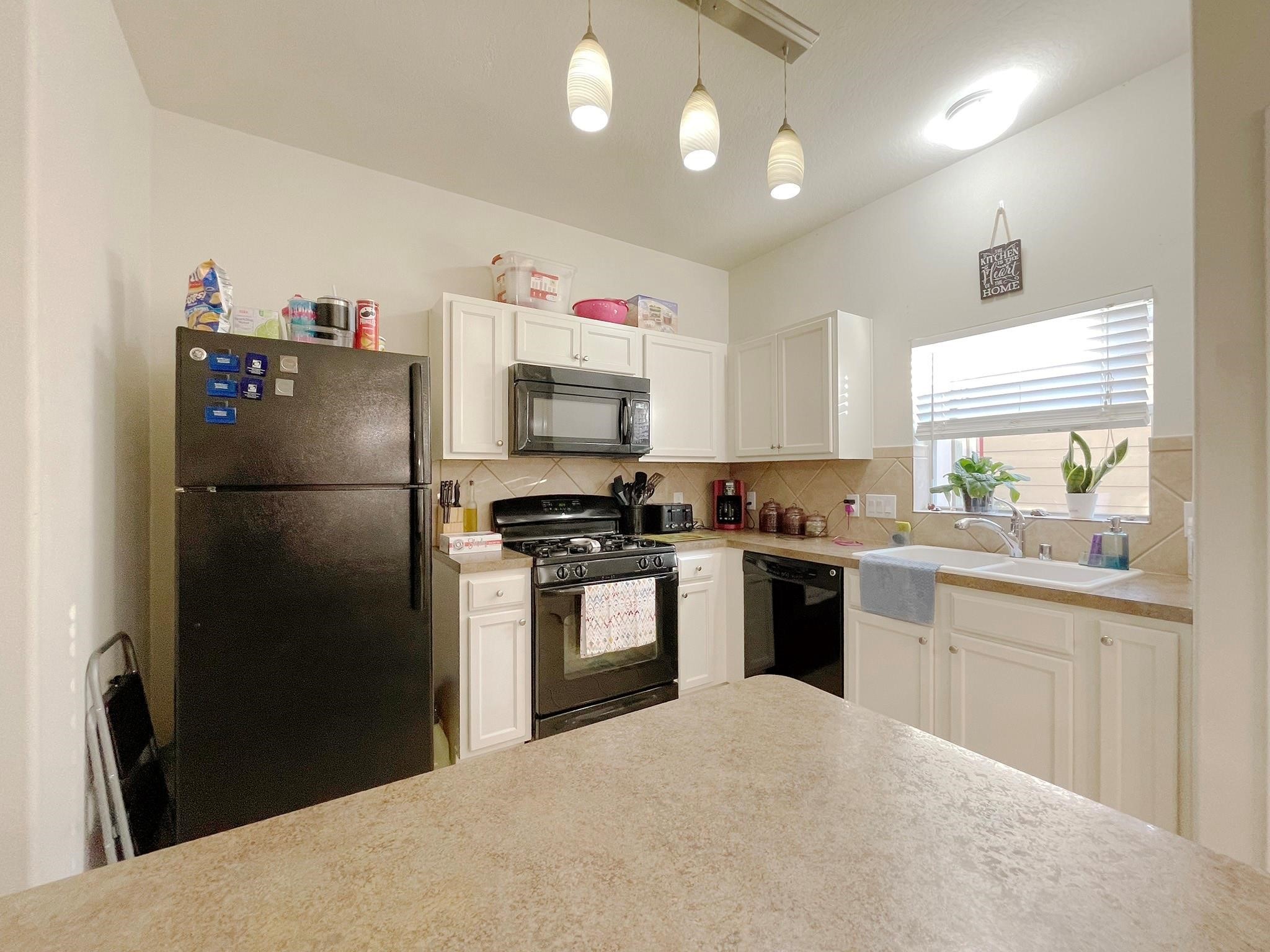 23614 Youpon Lake Lane Spring, TX 77373 - Photo 2 of 12 a kitchen with a refrigerator and a sink