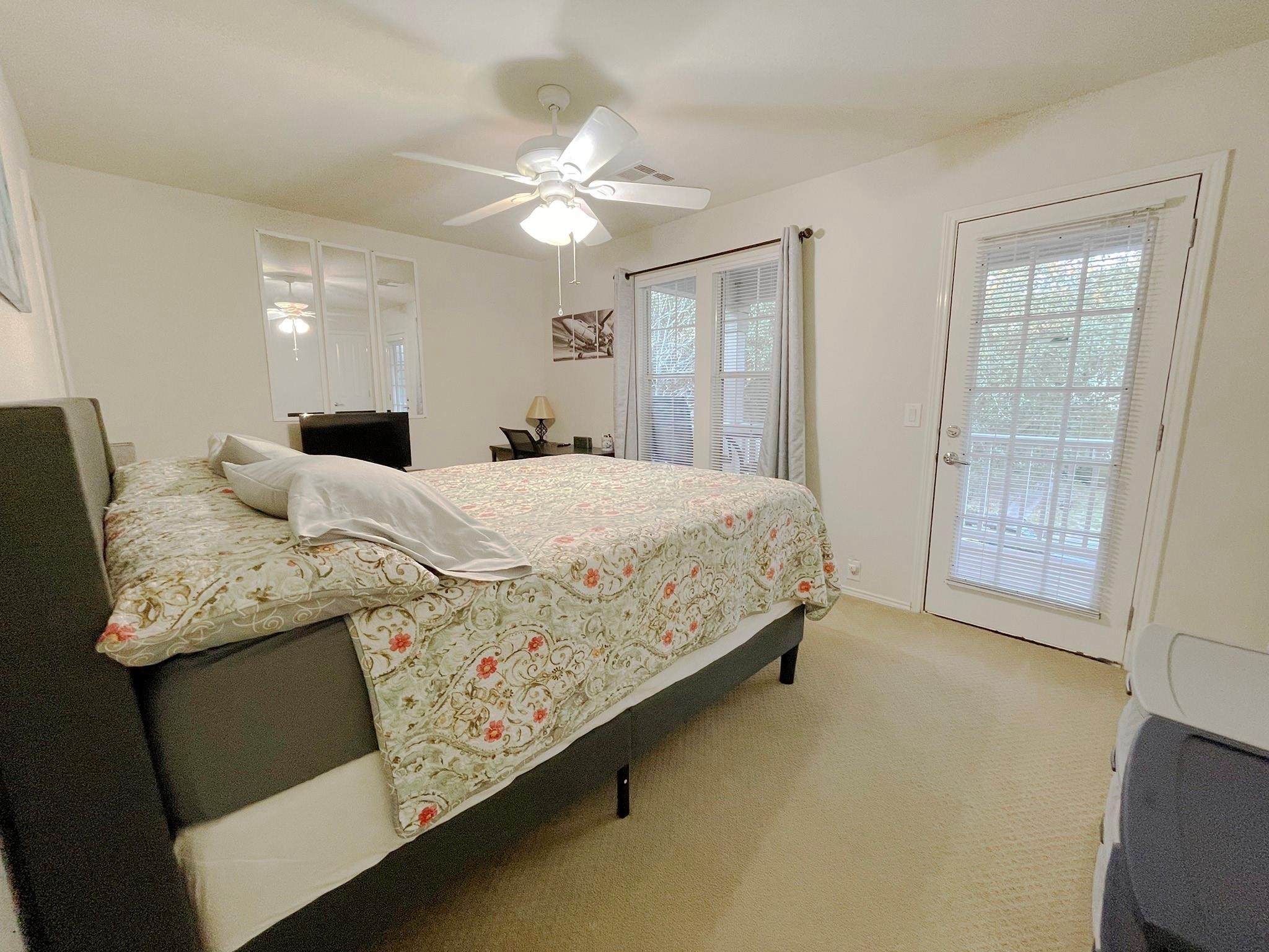 23614 Youpon Lake Lane Spring, TX 77373 - Photo 3 of 12 a bedroom with a bed and a chandelier