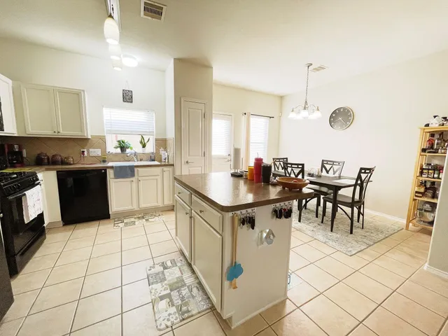 a kitchen with stainless steel appliances kitchen island granite countertop a sink and cabinets