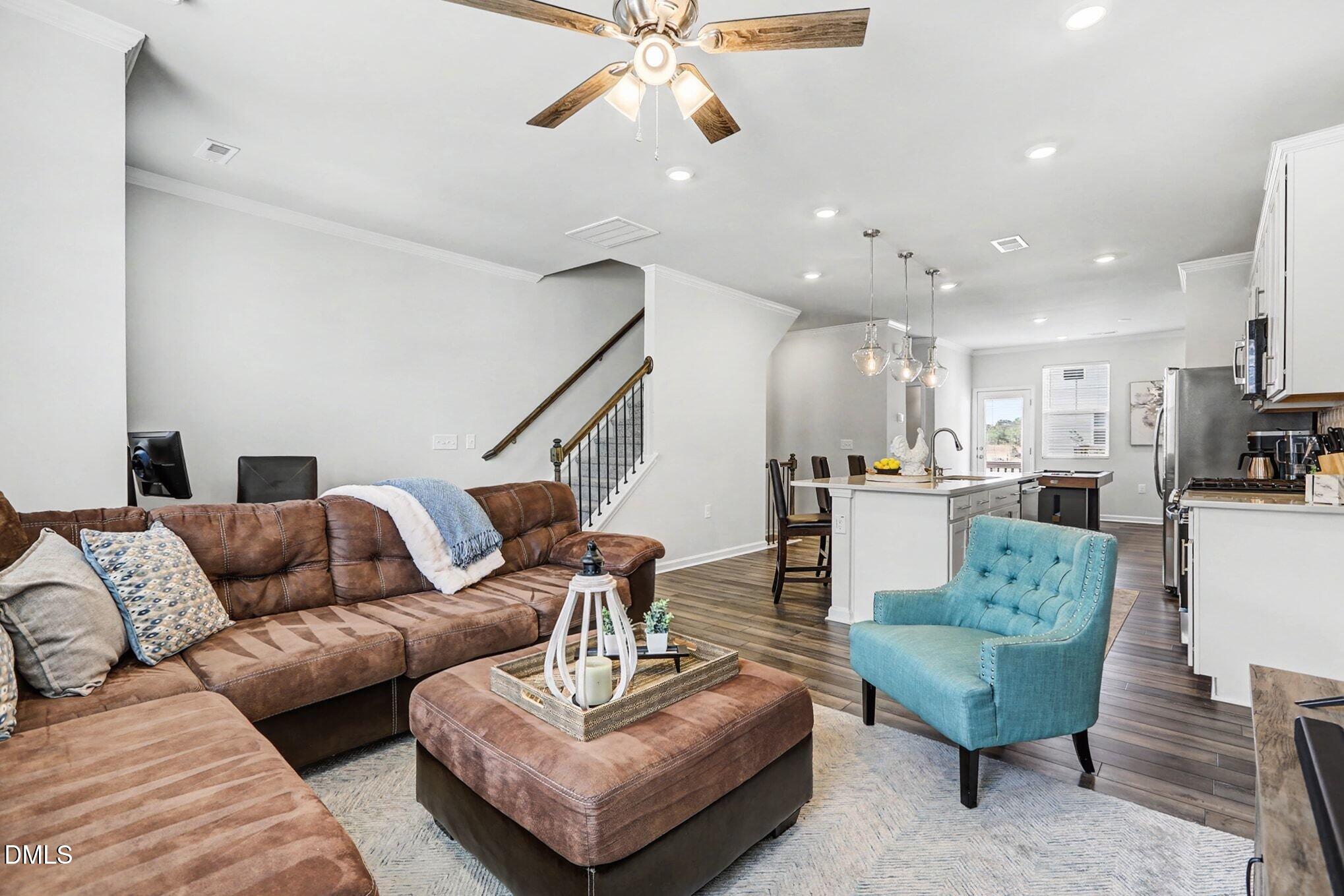 2528 Chert Lane Raleigh, NC 27610 - Photo 9 of 44 a living room with furniture kitchen view and a chandelier