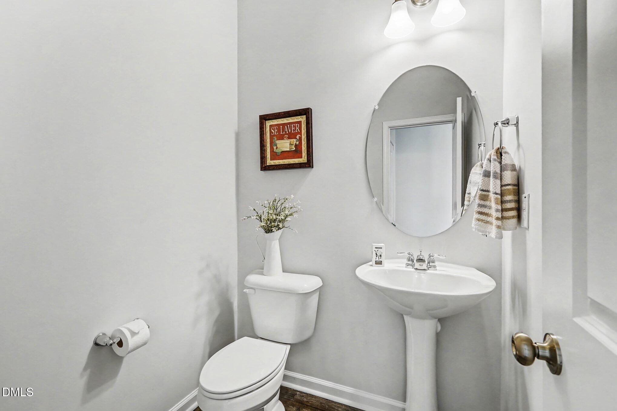 2528 Chert Lane Raleigh, NC 27610 - Photo 11 of 44 a bathroom with a toilet sink and mirror