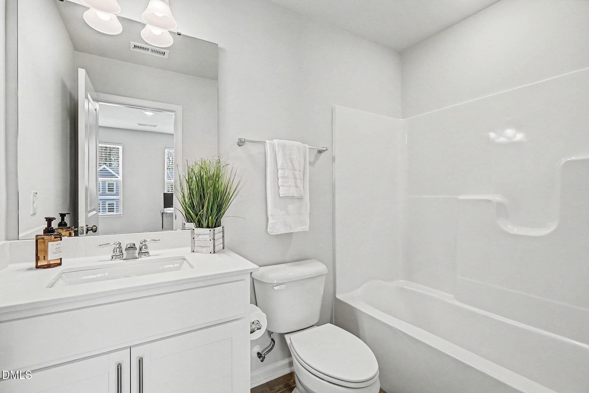 2528 Chert Lane Raleigh, NC 27610 - Photo 14 of 44 a bathroom with a sink toilet and shower