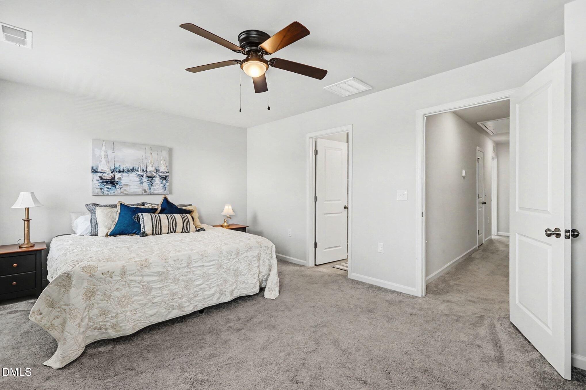 2528 Chert Lane Raleigh, NC 27610 - Photo 16 of 44 a bedroom with a bed chandelier fan and a bathroom