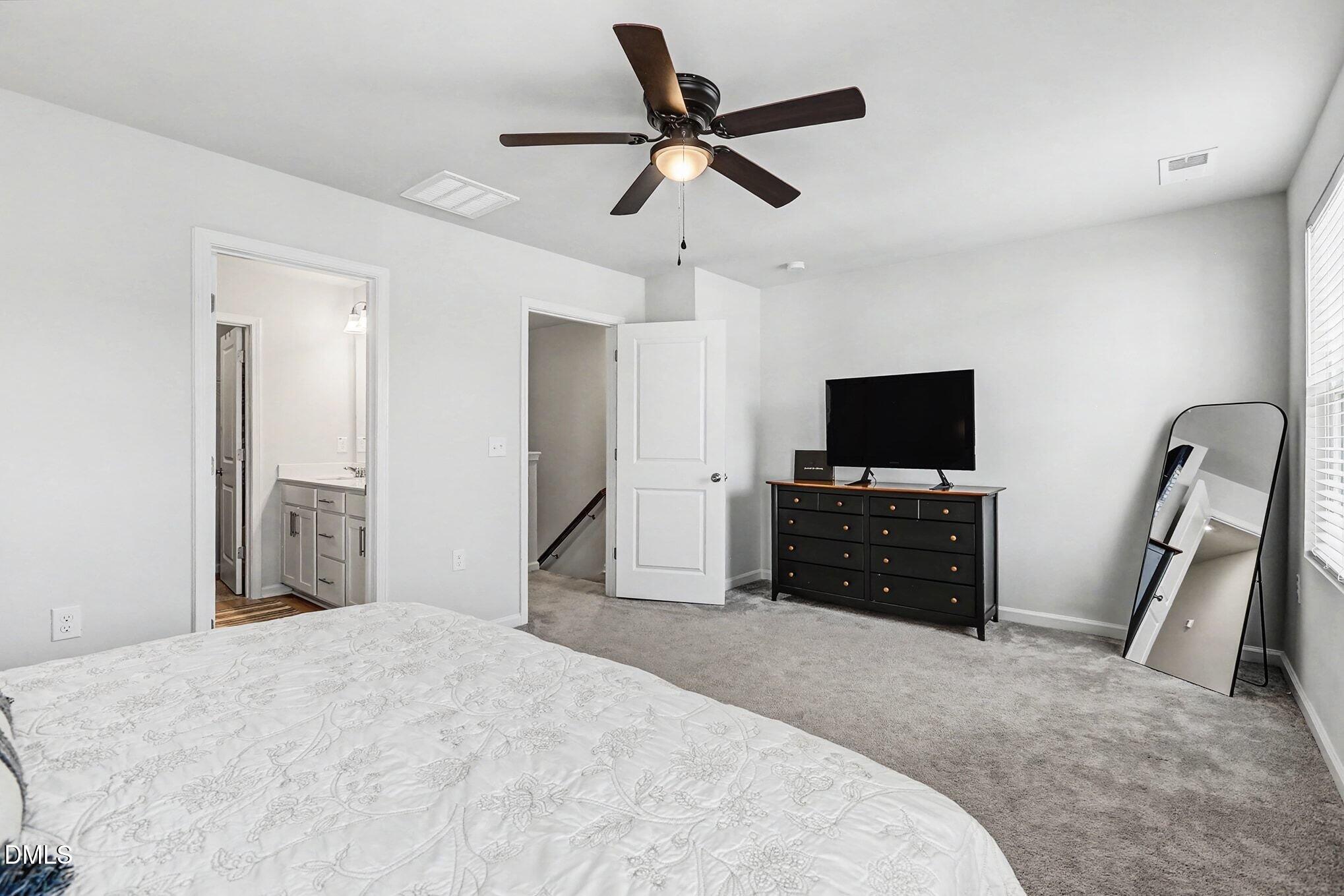 2528 Chert Lane Raleigh, NC 27610 - Photo 17 of 44 a bedroom with a bed and a flat screen tv