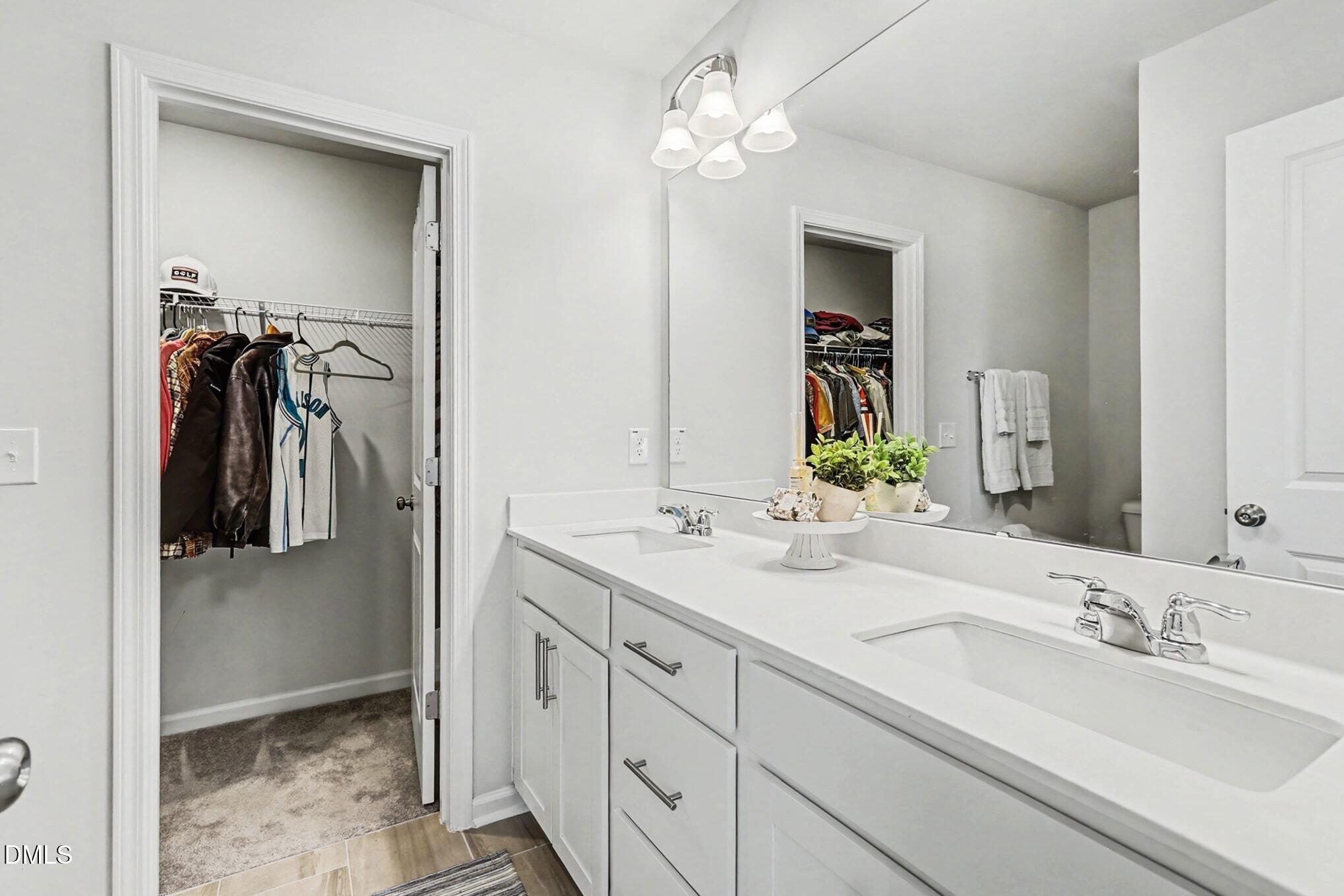 2528 Chert Lane Raleigh, NC 27610 - Photo 19 of 44 a bathroom with a double vanity sink and a mirror