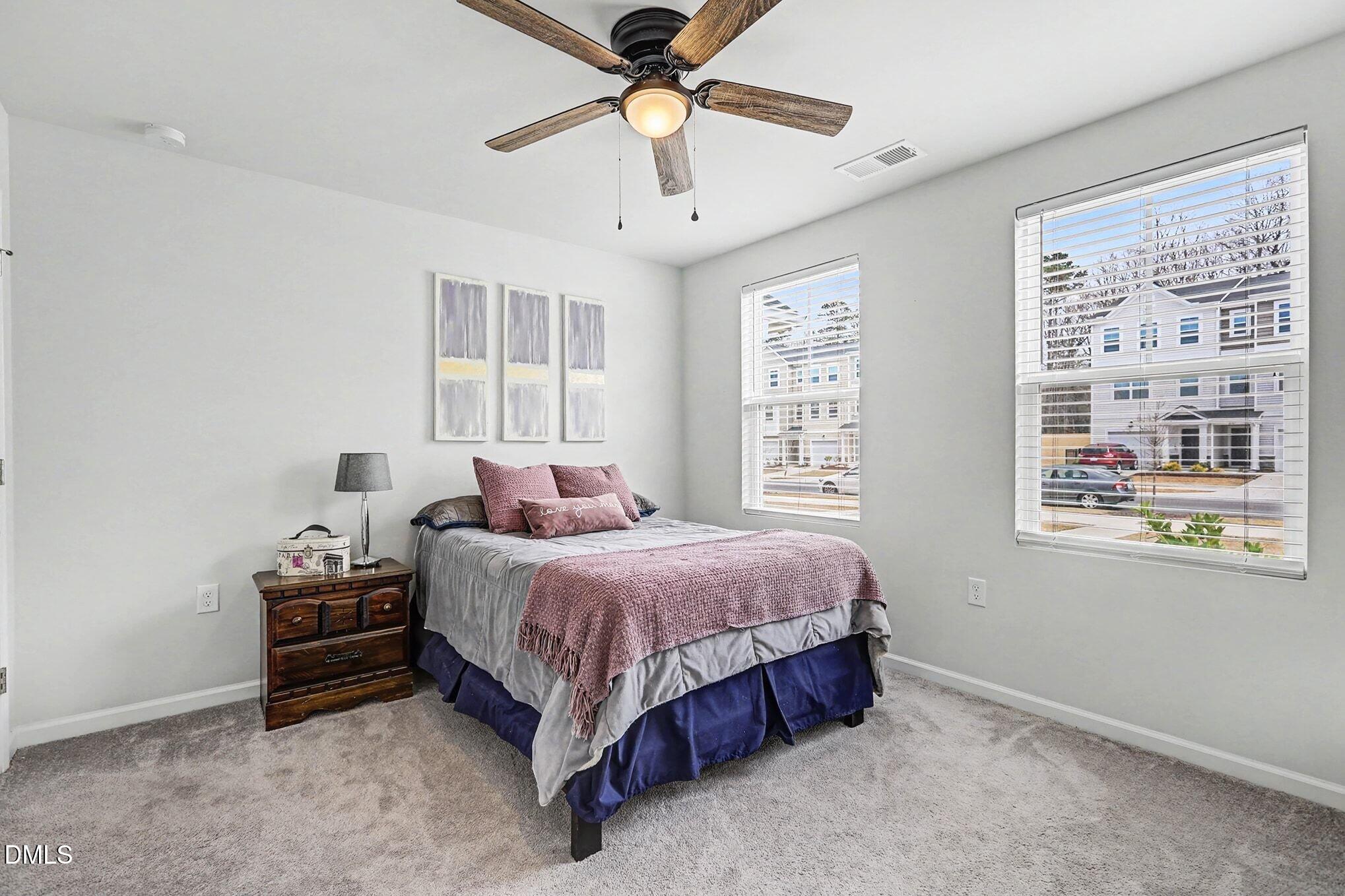 2528 Chert Lane Raleigh, NC 27610 - Photo 21 of 44 a spacious bedroom with a bed a window and closet