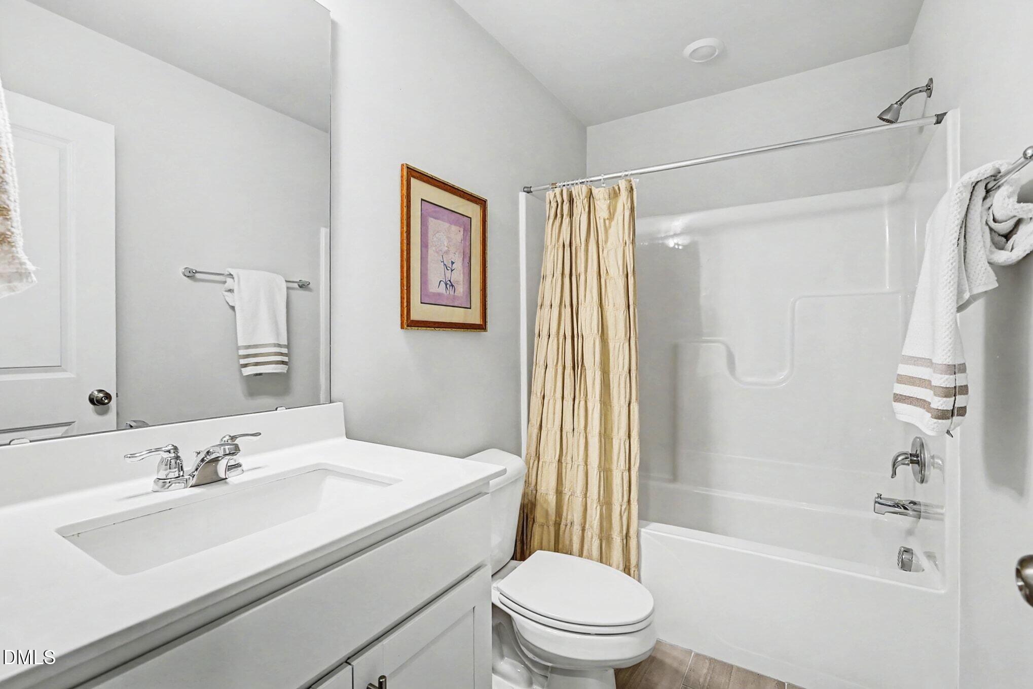 2528 Chert Lane Raleigh, NC 27610 - Photo 22 of 44 a bathroom with a sink toilet and shower