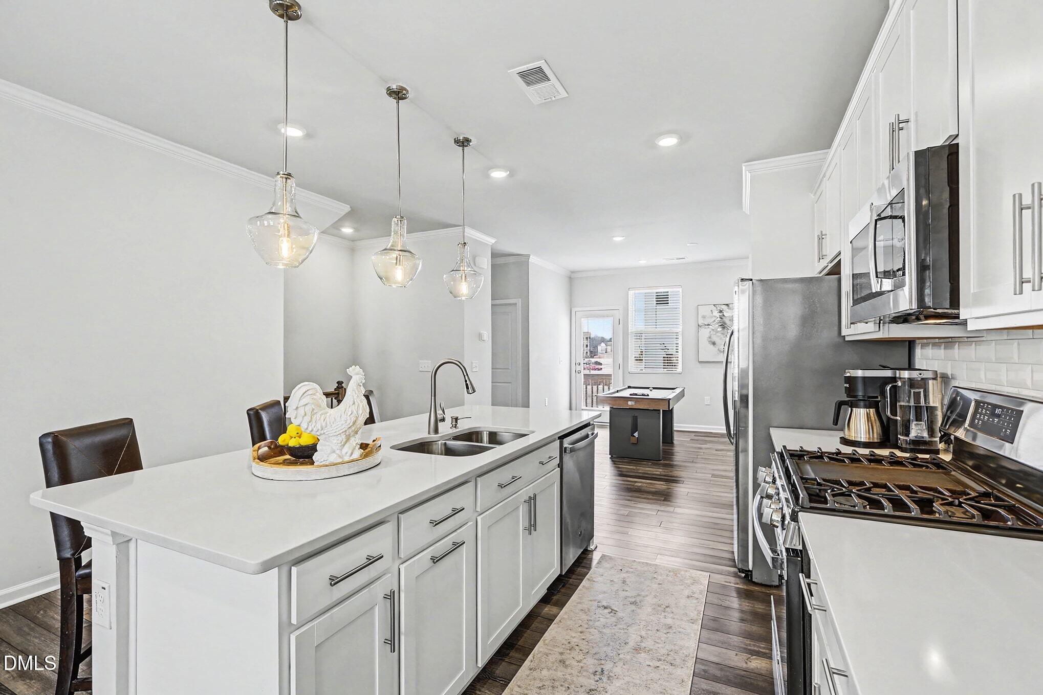 2528 Chert Lane Raleigh, NC 27610 - Photo 5 of 44 a kitchen with a sink a stove and chairs