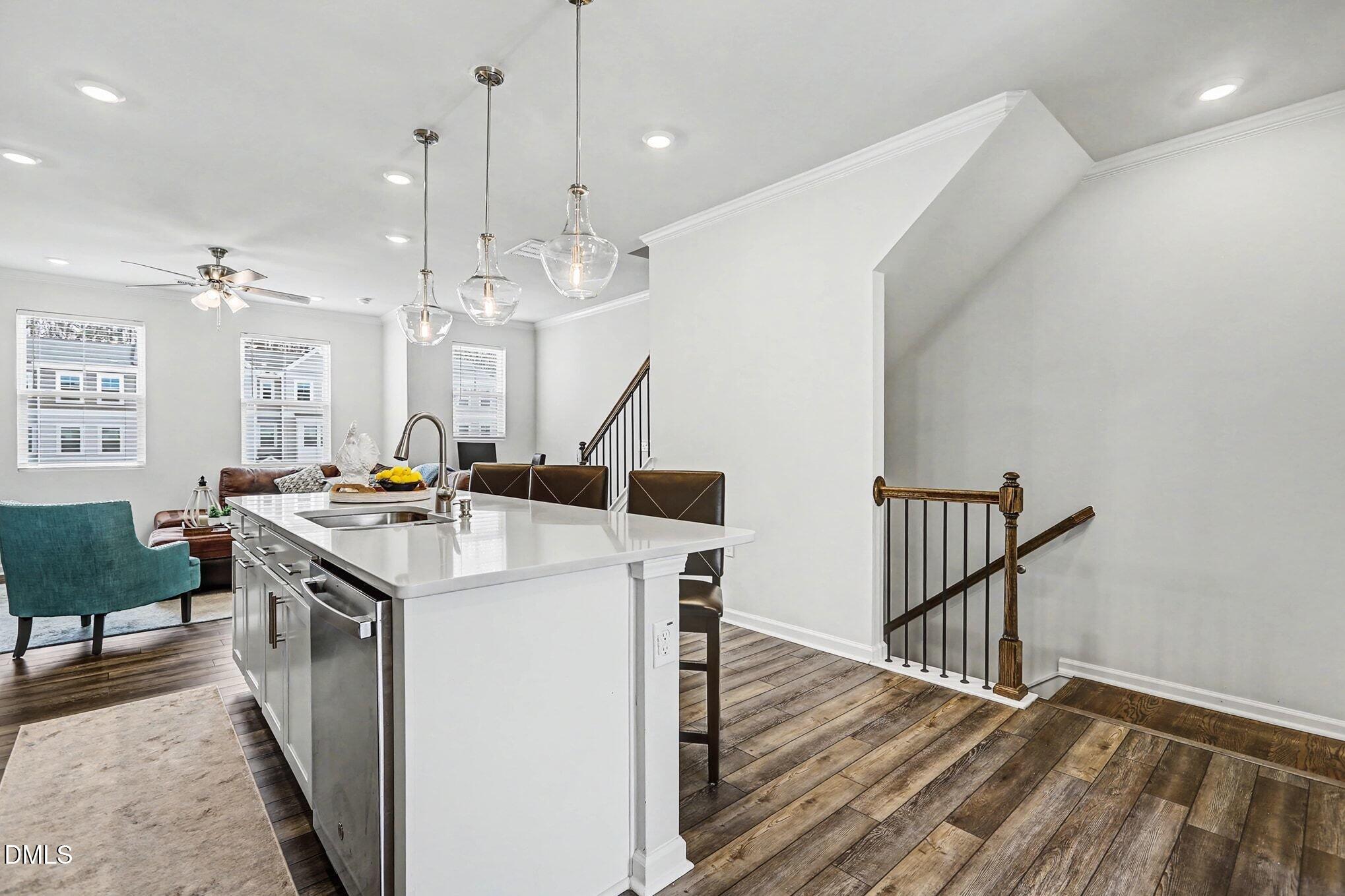 2528 Chert Lane Raleigh, NC 27610 - Photo 6 of 44 a kitchen with kitchen island a sink a stove a dining table and chairs
