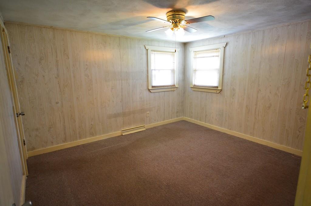 38 Cushing Road Webster, MA 01570 - Photo 12 of 18 an empty room with windows and fan