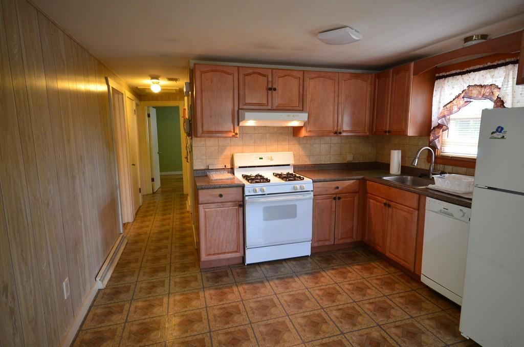 38 Cushing Road Webster, MA 01570 - Photo 9 of 18 a kitchen with a stove sink and cabinets
