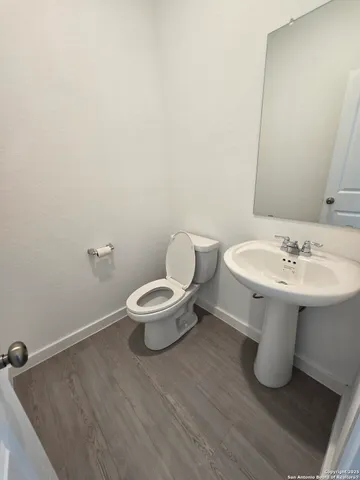 a bathroom with a sink toilet and a mirror