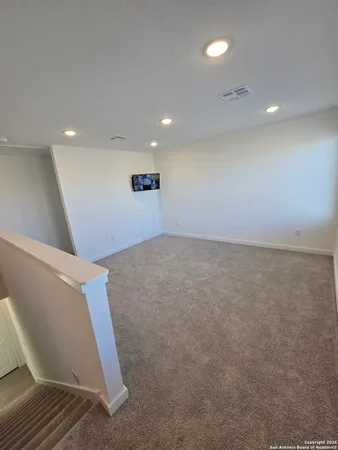 an empty room with wooden floor and entrance