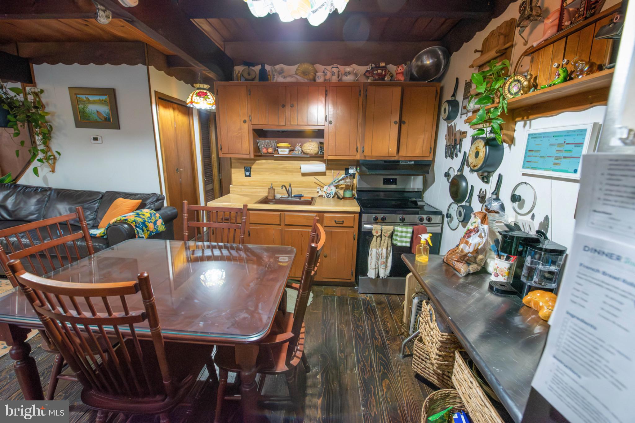 117 Swallow Circle Bushkill, PA 18324 - Photo 13 of 47 a view of a dining room with furniture a chandelier and wooden floor