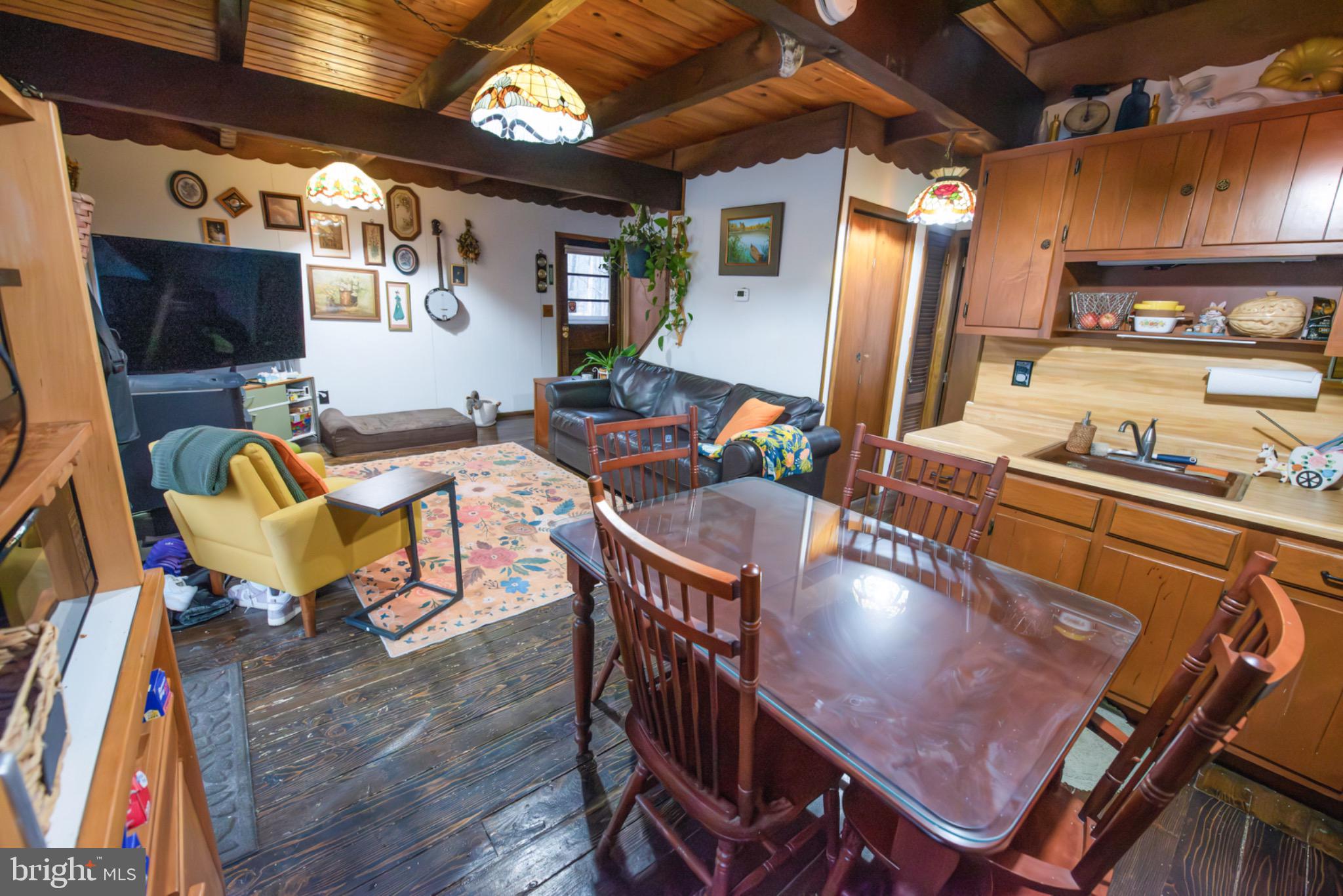 117 Swallow Circle Bushkill, PA 18324 - Photo 15 of 47 a dining room with furniture a rug and wooden floor