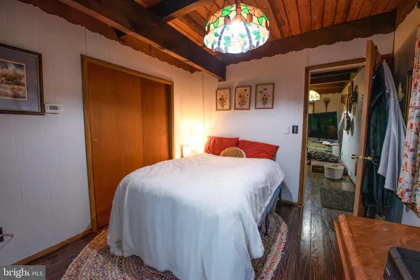 a bedroom with a bed and a chandelier