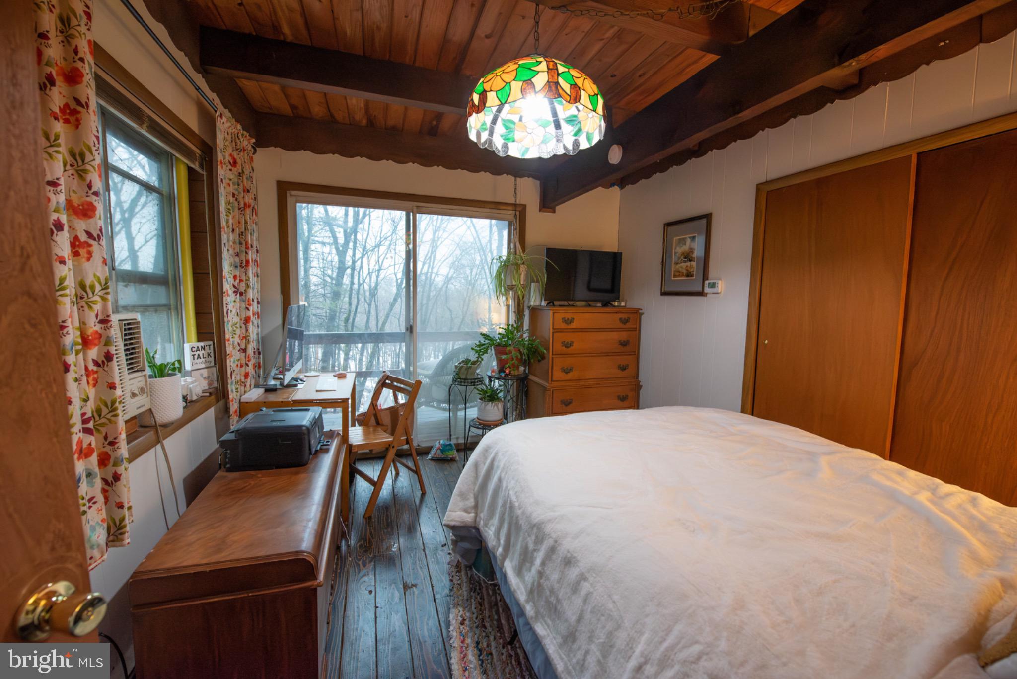 117 Swallow Circle Bushkill, PA 18324 - Photo 18 of 47 a spacious bedroom with a bed and a chandelier