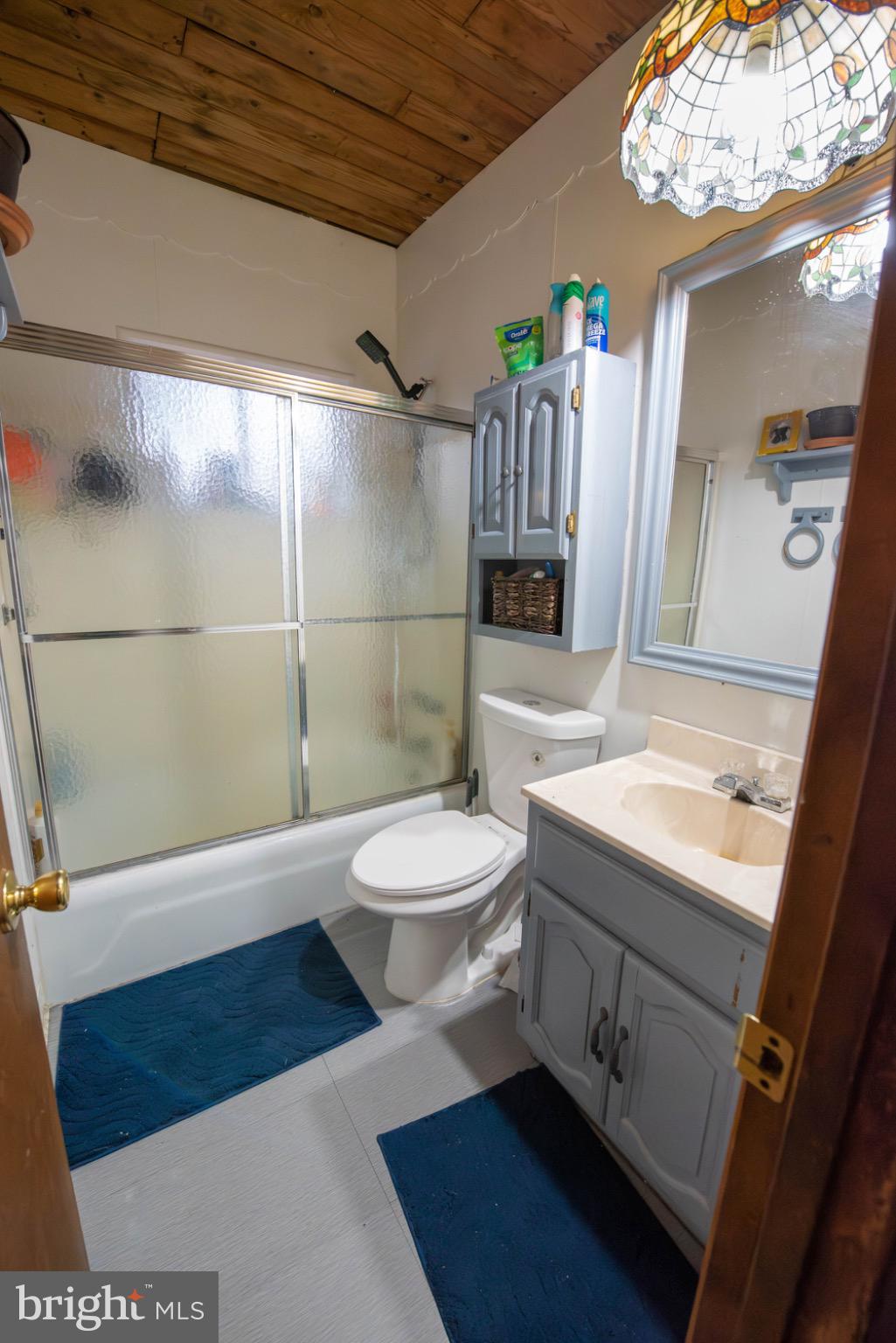 117 Swallow Circle Bushkill, PA 18324 - Photo 23 of 47 a bathroom with a sink a toilet a mirror and shower