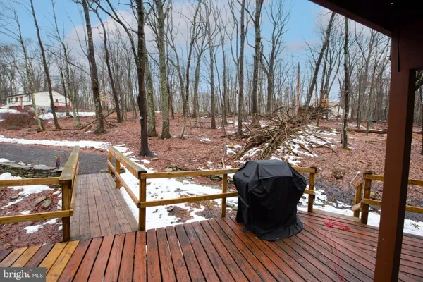 a view of a balcony with wooden floor and outdoor space