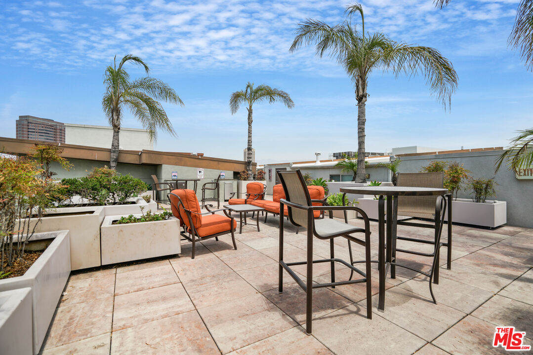 100 South Alameda Street, Unit 308 Los Angeles, CA 90012 - Photo 20 of 30 a view of a patio with a table and chairs