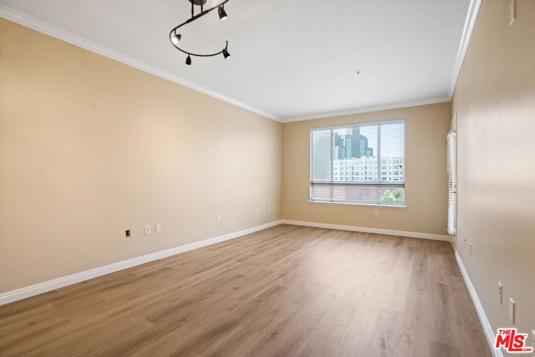 100 South Alameda Street, Unit 308 Los Angeles, CA 90012 - Photo 2 of 30 a view of room with window and wooden floor