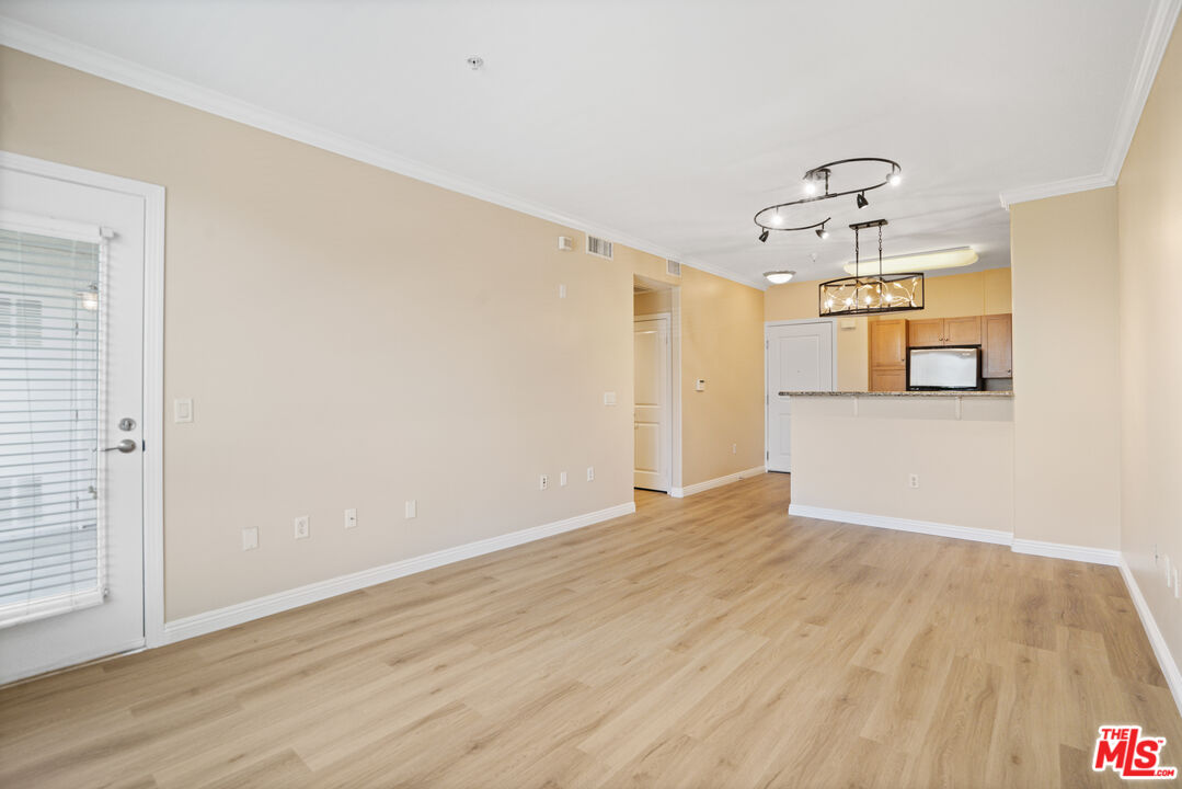 100 South Alameda Street, Unit 308 Los Angeles, CA 90012 - Photo 5 of 30 a view of a room with wooden floor and window
