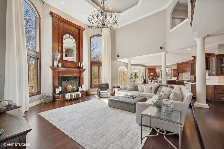 627 Alberosky Way Batavia, IL 60510 - Photo 13 of 73 a living room with furniture a fireplace and a chandelier