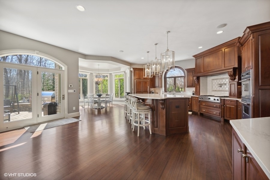 627 Alberosky Way Batavia, IL 60510 - Photo 15 of 73 a view of a dining room and livingroom with furniture wooden floor a chandelier