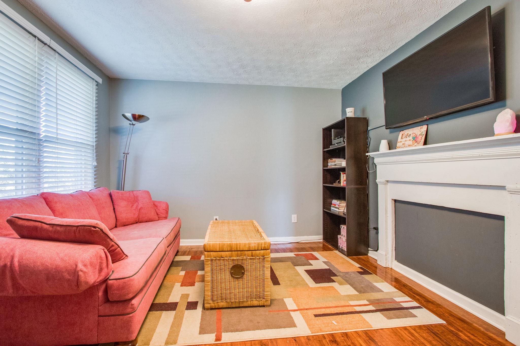 580 Curd Road Mount Juliet, TN 37122 - Photo 3 of 17 a living room with a couch and a flat screen tv