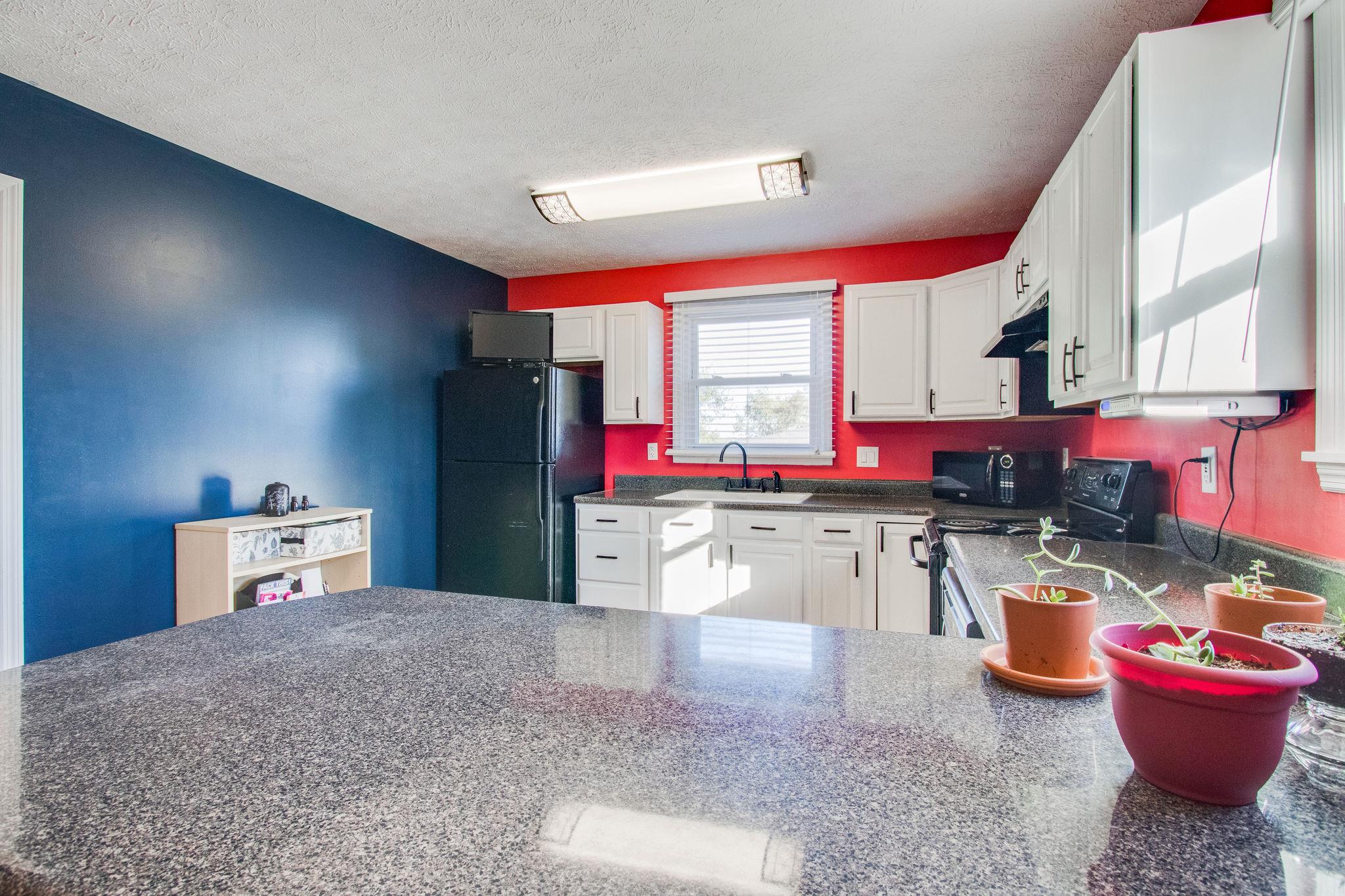 580 Curd Road Mount Juliet, TN 37122 - Photo 9 of 17 a kitchen with lots of counter top space and wooden floor