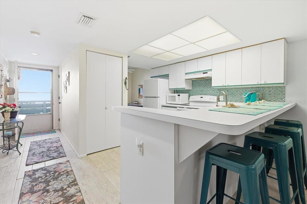 6800 Placida Road, Unit 192 Englewood, FL 34224 - Photo 11 of 33 a kitchen with stainless steel appliances a sink a stove a refrigerator and cabinets