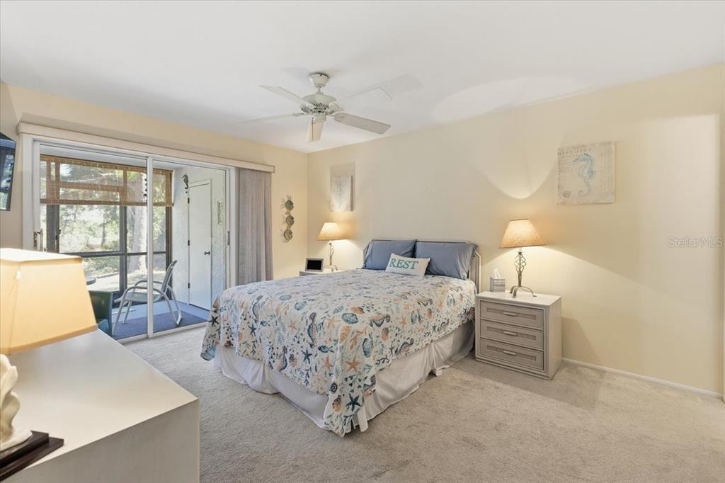 6800 Placida Road, Unit 192 Englewood, FL 34224 - Photo 15 of 33 a bedroom with a large bed and a chandelier