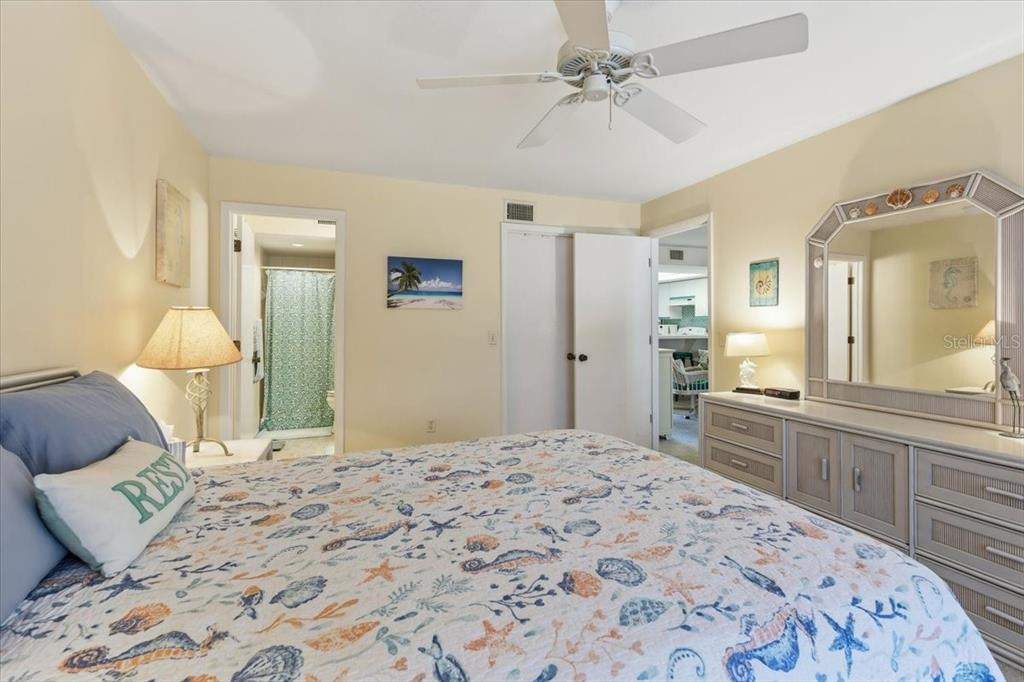 6800 Placida Road, Unit 192 Englewood, FL 34224 - Photo 16 of 33 a bedroom with a large bed and a chandelier