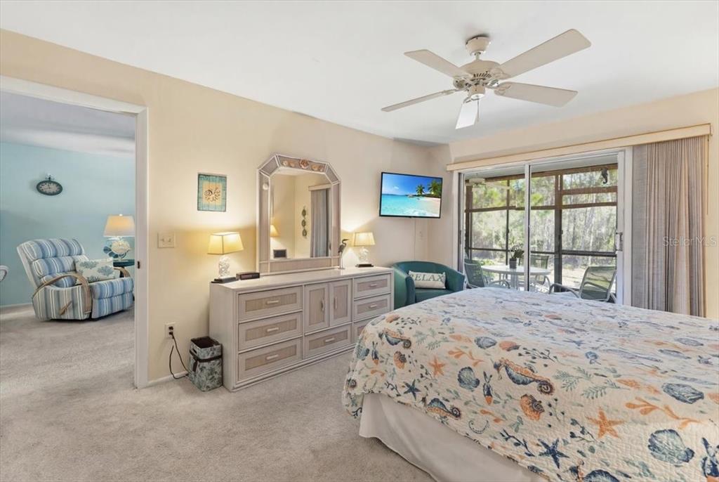 6800 Placida Road, Unit 192 Englewood, FL 34224 - Photo 17 of 33 a bedroom with a bed and a chandelier