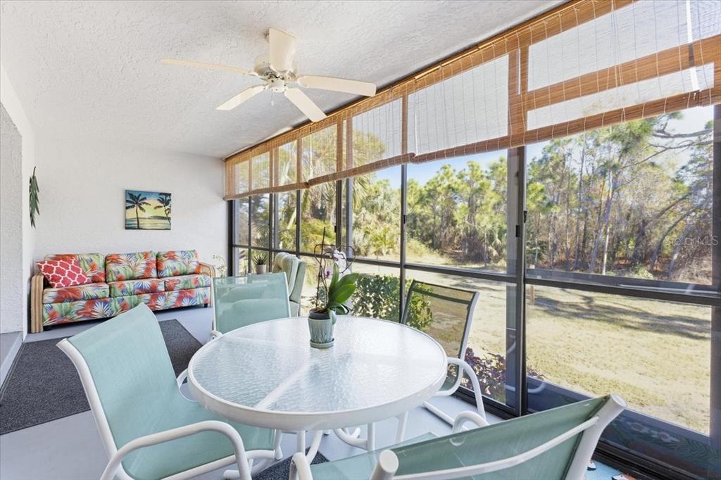 6800 Placida Road, Unit 192 Englewood, FL 34224 - Photo 23 of 33 a dining room with furniture a chandelier and wooden floor