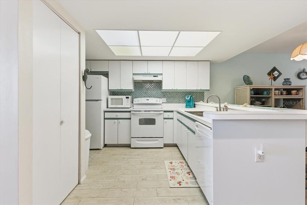 6800 Placida Road, Unit 192 Englewood, FL 34224 - Photo 4 of 33 a kitchen with a sink a stove a refrigerator and a window