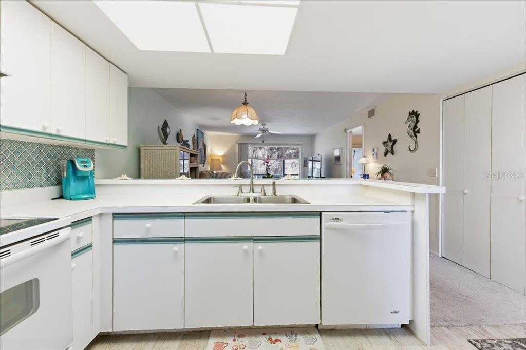 6800 Placida Road, Unit 192 Englewood, FL 34224 - Photo 6 of 33 a kitchen with white cabinets and sink
