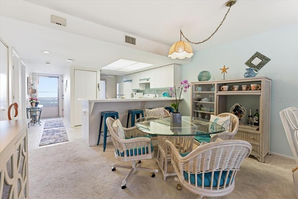 6800 Placida Road, Unit 192 Englewood, FL 34224 - Photo 9 of 33 a dining room with furniture a rug and wooden floor