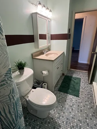 a bathroom with a toilet sink and mirror