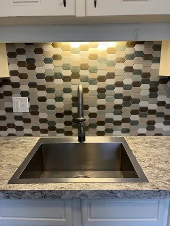 a kitchen with a wooden floor and white cabinets