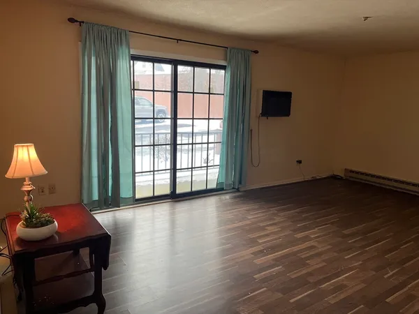 a view of a livingroom with furniture and a window