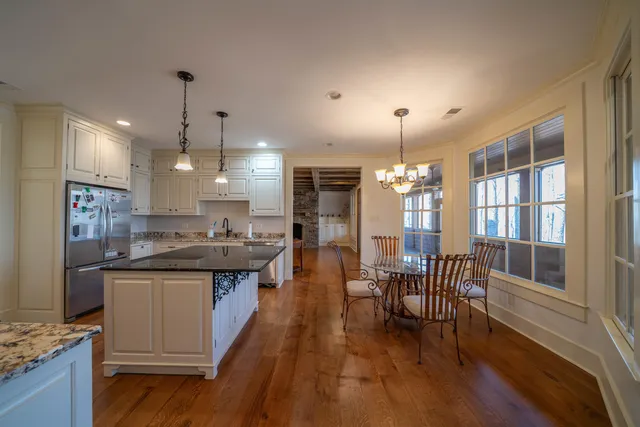 a kitchen with lots of counter top space and dining table